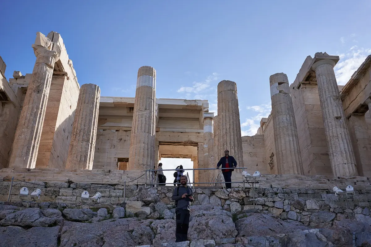 Visitors climbing through the Propylaea, the ancient gateway to the Acropolis